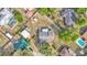 Aerial view of a home, fully-fenced backyard, storage sheds, patio and lush, mature trees in a quiet neighborhood at 1423 Ridgegreen N Loop, Lakeland, FL 33809