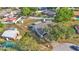 Bird's eye view of a home with a large, fenced backyard, storage sheds, and surrounded by mature shade trees at 1423 Ridgegreen N Loop, Lakeland, FL 33809
