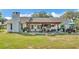 Home featuring a lovely backyard with a covered patio, fire pit, plenty of space for entertaining or relaxation at 1423 Ridgegreen N Loop, Lakeland, FL 33809