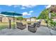 A backyard with patio furniture, umbrella, fire pit, shed and blue skies at 1423 Ridgegreen N Loop, Lakeland, FL 33809