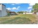 Large backyard with covered patio, shed, offering ample space for outdoor activities, gardening, and entertaining at 1423 Ridgegreen N Loop, Lakeland, FL 33809