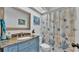 The bathroom offers a vanity with granite counters, a decorative mirror and a shower with themed curtain at 1423 Ridgegreen N Loop, Lakeland, FL 33809