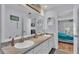 Modern bathroom with double sinks, granite countertops, and plenty of storage at 1423 Ridgegreen N Loop, Lakeland, FL 33809