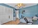 Relaxing bedroom with closet, wood look flooring, and a ceiling fan at 1423 Ridgegreen N Loop, Lakeland, FL 33809