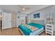 Cozy bedroom featuring light walls, wood floors, and beach-themed decor at 1423 Ridgegreen N Loop, Lakeland, FL 33809