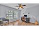 Bedroom offering wood-look flooring, a ceiling fan and ample natural light at 1423 Ridgegreen N Loop, Lakeland, FL 33809