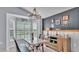 Inviting dining room featuring natural light, rustic furniture, a modern chandelier, and stylish decor at 1423 Ridgegreen N Loop, Lakeland, FL 33809
