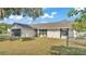 Charming single-story home featuring a two-car garage, and well-maintained lawn and landscape at 1423 Ridgegreen N Loop, Lakeland, FL 33809