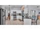 Open kitchen with granite counters, stainless steel appliances, white cabinetry, and breakfast bar at 1423 Ridgegreen N Loop, Lakeland, FL 33809
