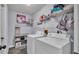 Functional laundry room with modern washer and dryer, shelving, and neutral paint at 1423 Ridgegreen N Loop, Lakeland, FL 33809