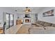 Cozy living room featuring a stone fireplace, ceiling fan, stylish decor, and neutral color palette at 1423 Ridgegreen N Loop, Lakeland, FL 33809