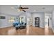 Open living room with wood-look floors, large windows, and ample seating for relaxing and entertaining at 1423 Ridgegreen N Loop, Lakeland, FL 33809
