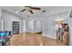 Cozy living room featuring wood-look floors, neutral walls, and open access to other living areas at 1423 Ridgegreen N Loop, Lakeland, FL 33809