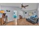 Spacious living room with vaulted ceiling, ceiling fan, and wood-look floors, creating a warm ambiance at 1423 Ridgegreen N Loop, Lakeland, FL 33809