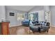 Bright living room featuring wood-look floors, comfortable seating, and natural light at 1423 Ridgegreen N Loop, Lakeland, FL 33809
