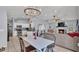 Open-concept space showcasing a living room fireplace, a dining area with a modern chandelier, and a kitchen at 1423 Ridgegreen N Loop, Lakeland, FL 33809