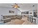Bright, open concept living space with a dining room, kitchen bar, and a comfortable sectional sofa at 1423 Ridgegreen N Loop, Lakeland, FL 33809