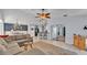 Open floor plan featuring a living room with a stone fireplace and a dining area with modern chandelier at 1423 Ridgegreen N Loop, Lakeland, FL 33809