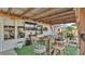 Covered outdoor patio boasts a bar-height table, outdoor TV, and backyard view at 1423 Ridgegreen N Loop, Lakeland, FL 33809