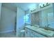 Luxurious bathroom with double sinks, granite countertop, and a glass-enclosed shower at 1529 Leamington Ln, Winter Haven, FL 33884