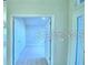 View of the home's hallway with light wood-look floors and a doorway to a bedroom at 1529 Leamington Ln, Winter Haven, FL 33884