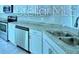 Contemporary kitchen design showcasing stainless steel dishwasher and granite countertops at 1529 Leamington Ln, Winter Haven, FL 33884