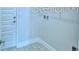 The laundry room features durable tile flooring and convenient access to exterior, providing a practical space at 1529 Leamington Ln, Winter Haven, FL 33884