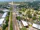 Wide aerial view showcasing neighborhood, green landscape, roads, and nearby buildings in the surrounding area at 1648 Skinner St, Lakeland, FL 33801
