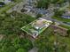 Aerial view of home showcasing lush surroundings and proximity to neighborhood amenities within property lines at 1648 Skinner St, Lakeland, FL 33801