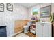 Stylish bathroom features wallpaper, tiled walls, a vanity with storage, and modern fixtures at 1648 Skinner St, Lakeland, FL 33801