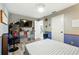 Bedroom features a checkered bed, television, storage units, and is brightly lit at 1648 Skinner St, Lakeland, FL 33801
