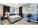 Bedroom with wood floors, stylish decor, and comfortable furnishings, creating a relaxing space at 1648 Skinner St, Lakeland, FL 33801