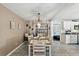 Open dining area with modern decor, adjacent to kitchen with white cabinets at 1648 Skinner St, Lakeland, FL 33801
