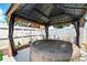 Relax in this backyard hot tub under a charming gazebo with draped sides for privacy at 1648 Skinner St, Lakeland, FL 33801