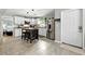 Bright kitchen featuring white cabinets, stainless steel appliances, and an island with seating at 1648 Skinner St, Lakeland, FL 33801