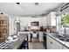 Updated kitchen boasting white cabinets, stainless steel appliances, granite counters, and eat-in island at 1648 Skinner St, Lakeland, FL 33801