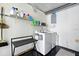 Bright laundry room with shelving and front loading washer and dryer for convenience and organized chores at 1648 Skinner St, Lakeland, FL 33801