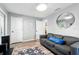 This living room has light gray walls, wood-look floors, and a comfortable gray sofa with a blue pillow at 1648 Skinner St, Lakeland, FL 33801