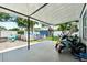 This covered patio includes a hot tub, seating area, and ample space for recreational vehicles at 1648 Skinner St, Lakeland, FL 33801