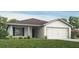 Charming single-story home with a well-manicured lawn, two-car garage, and inviting entrance at 1814 Daystar Dr, Haines City, FL 33844