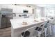 Modern kitchen with an oversized white quartz countertop island, stainless steel appliances, and white cabinets at 1823 Daystar Dr, Haines City, FL 33844