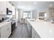 Bright kitchen featuring white cabinets, stainless steel appliances, and a large island with seating at 1823 Daystar Dr, Haines City, FL 33844