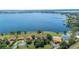 Aerial view of lakefront property with private docks, lush landscaping, and community tennis courts at 188 Morning Dew Ct, Winter Haven, FL 33884