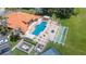 An aerial view of the community pool, clubhouse, tennis court, shuffleboard and landscaping at 188 Morning Dew Ct, Winter Haven, FL 33884