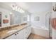 Bright bathroom with a double vanity, soaking tub, and a glass-enclosed shower at 188 Morning Dew Ct, Winter Haven, FL 33884