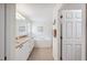 Bright bathroom with a double vanity, soaking tub, and glass-enclosed shower at 188 Morning Dew Ct, Winter Haven, FL 33884