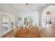 Formal dining room with hardwood floors, a large wooden table, and ample natural light at 188 Morning Dew Ct, Winter Haven, FL 33884