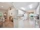Open-concept kitchen boasts granite countertops, white cabinets, stainless appliances, and tile floors at 188 Morning Dew Ct, Winter Haven, FL 33884