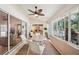 Enclosed lanai with ceiling fan, neutral walls, patio table, and views of the landscape at 188 Morning Dew Ct, Winter Haven, FL 33884