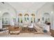 Large living room with high ceilings, arched windows, and neutral-toned furniture at 188 Morning Dew Ct, Winter Haven, FL 33884